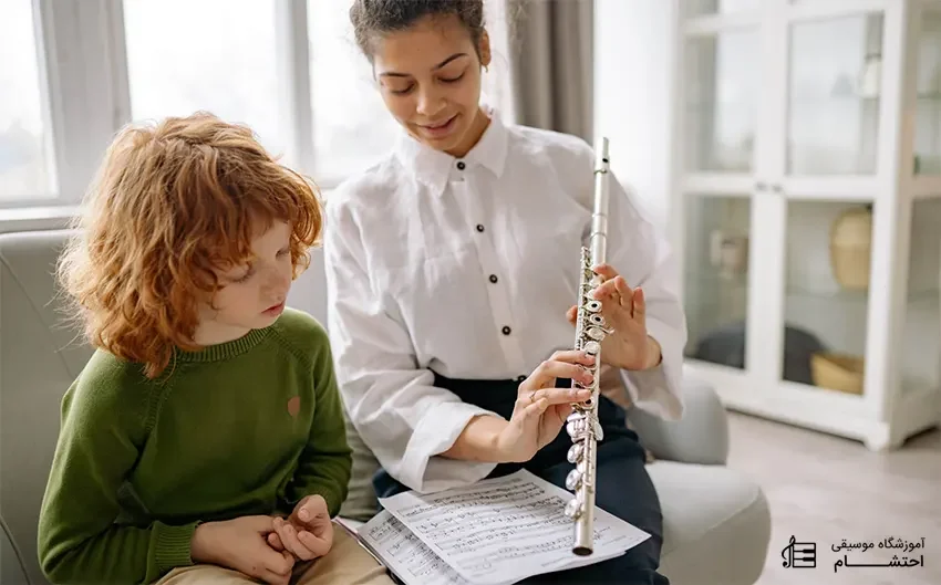 a women teaching flute to a kid