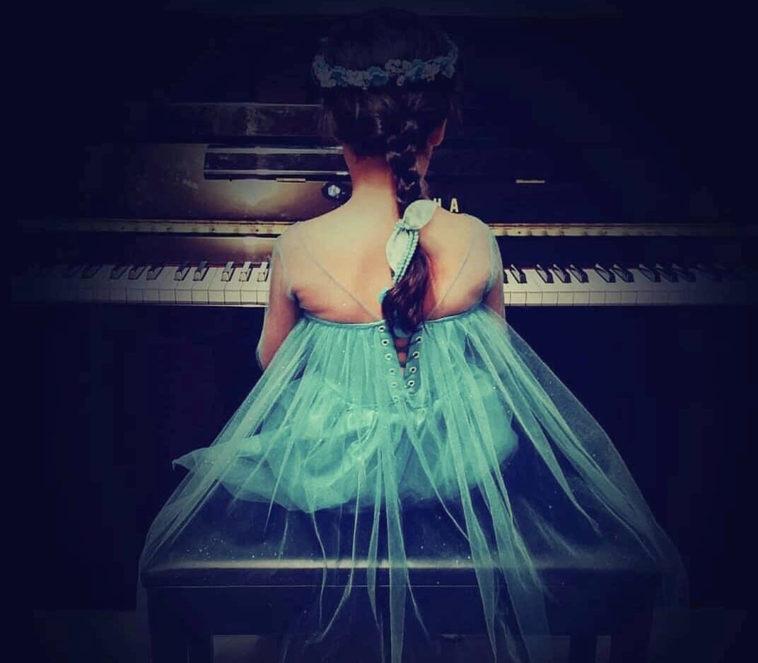 small girl playing piano