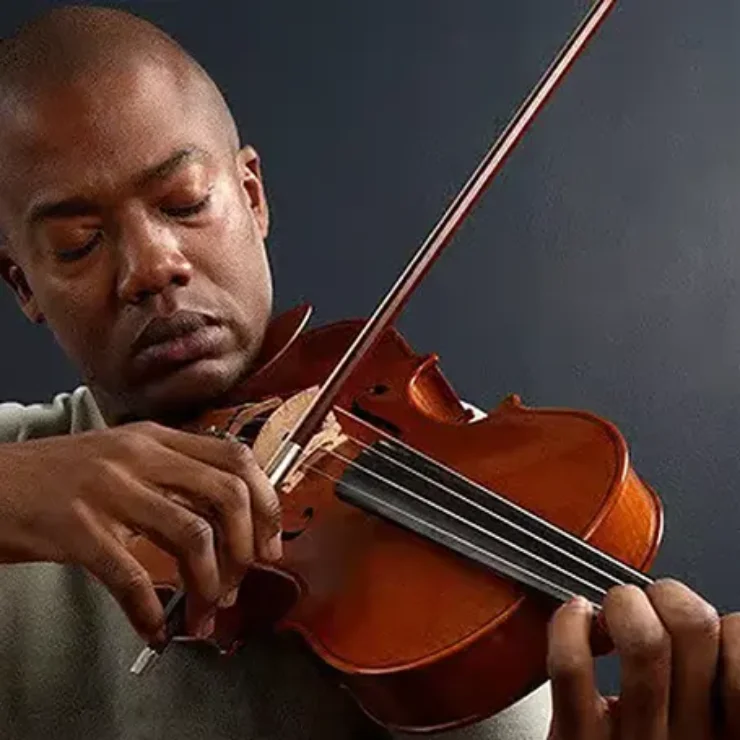 a man playing violon with eyes closed