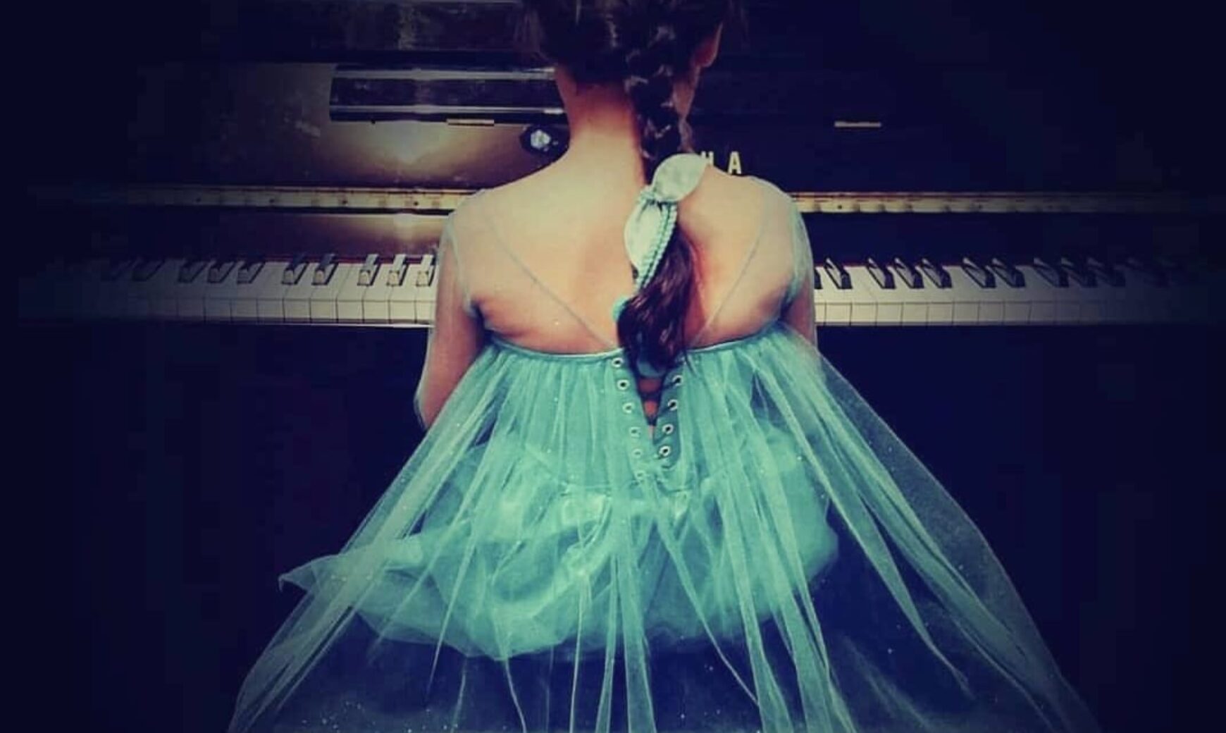small girl playing piano