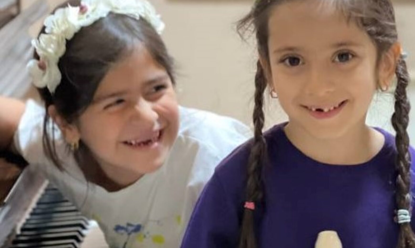 two children are smiling